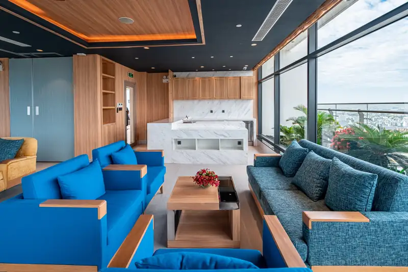 Executive Lounge với sofa xanh và cửa kính nhìn ra biển, Mikazuki Đà Nẵng