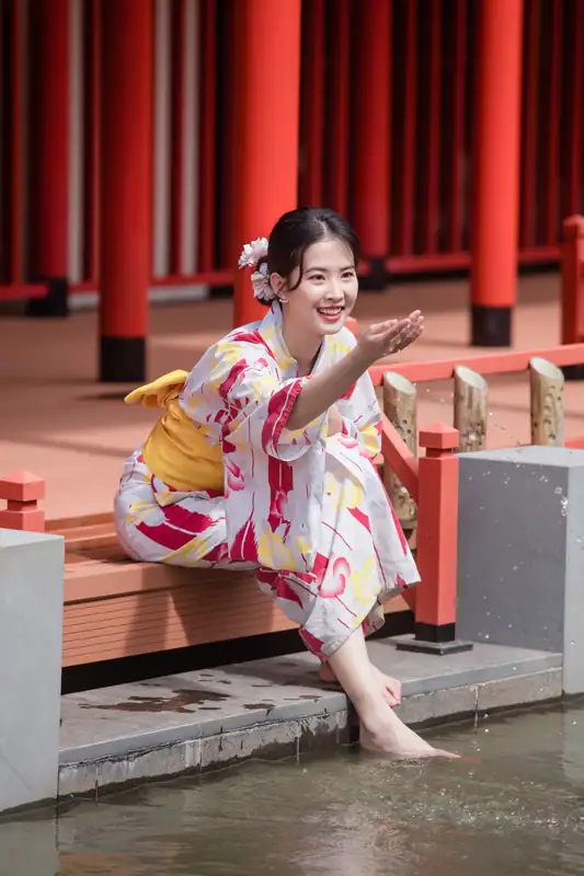 Khách mặc yukata ngồi nhúng chân xuống nước bên hiên gỗ cột đỏ, Mikazuki Đà Nẵng